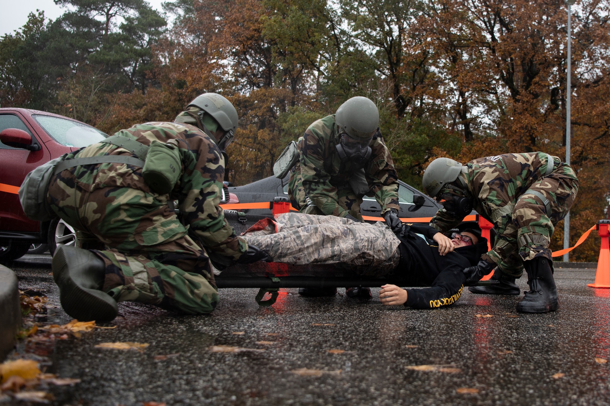 U.S. Air Force 52nd Medical Group Airmen begin moving a mock patient during exercise Sabre Storm, Nov. 3, 2021, on Spangdahlem Air Base, Germany. These readiness exercises enable 52nd MDG Airmen to test their Installation Medical All Hazards Response teams, which respond, test and treat for possible exposure to chemical, biological, radiological or nuclear threats. (U.S. Air Force photo by Staff Sgt. Melody W. Howley)