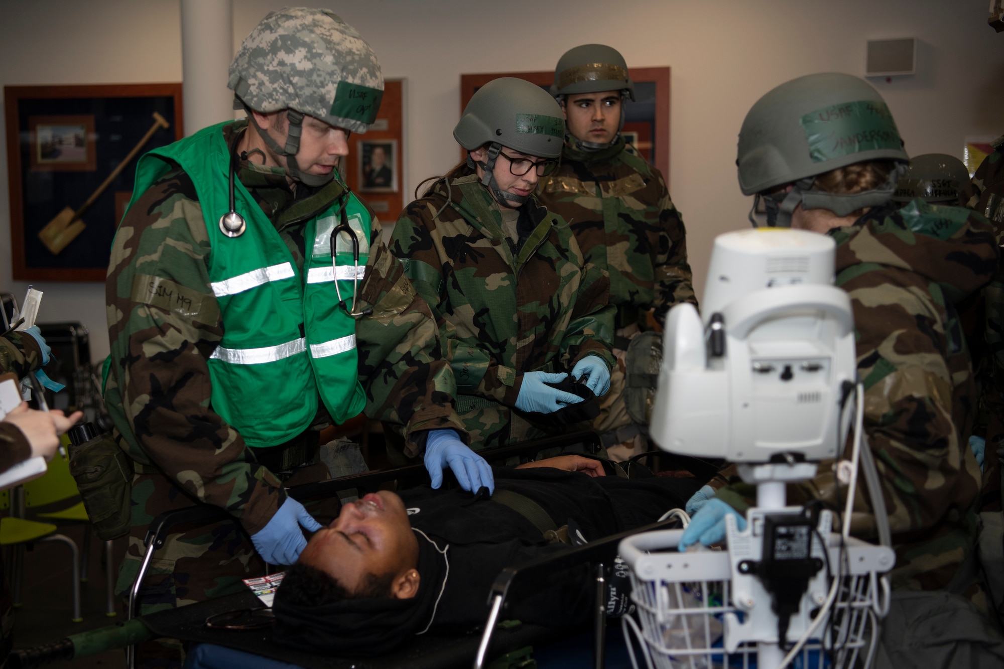 U.S. Air Force 52nd Medical Group Airmen assess a mock patient during exercise Sabre Storm, Nov. 3, 2021, on Spangdahlem Air Base, Germany. After the victim goes through the decontamination process, they begin evaluating the patient for injuries and potential contamination exposure. (U.S. Air Force photo by Staff Sgt. Melody W. Howley)