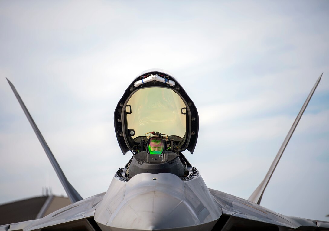 A U.S. Air Force pilot performs post-flight checks in cockpit of a F-22 A Raptor.