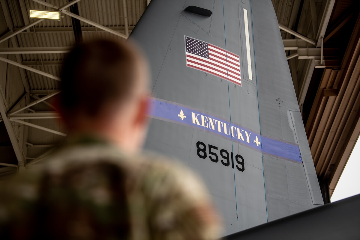An Airman from the 123rd Maintenance Group observes the freshly-applied tail art of one of the Kentucky Air National Guard’s newly acquired C-130J Super Hercules aircraft at Channel Islands Air Guard Station in Port Hueneme, Calif., Nov. 3, 2021. The aircraft is replacing the C-130H Hercules, which has been in service to the Kentucky Air National Guard since 1992. (U.S. Air National Guard photo by Tech. Sgt. Joshua Horton)
