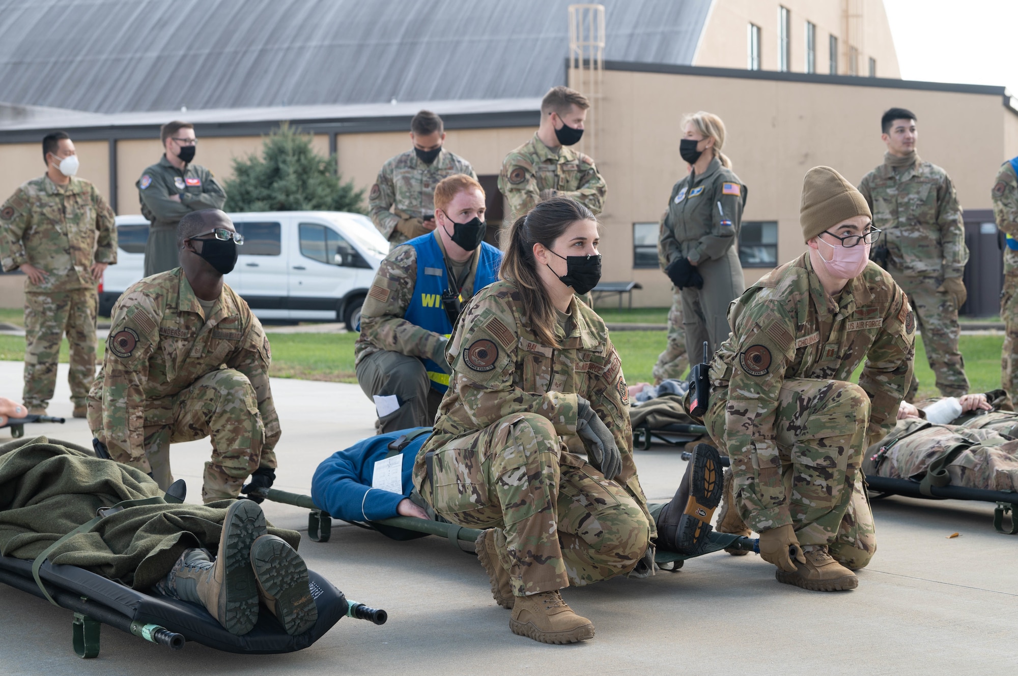 Airmen from the 375th Aeromedical Evacuation Squadron prepare to lift a simulated injured patient during an exercise on Scott Air Force Base, Illinois, Nov. 3, 2021. The exercise was designed to prepare Airmen for real-world medical evacuations. (U.S. Air Force photo by Airman 1st Class Stephanie Henry)