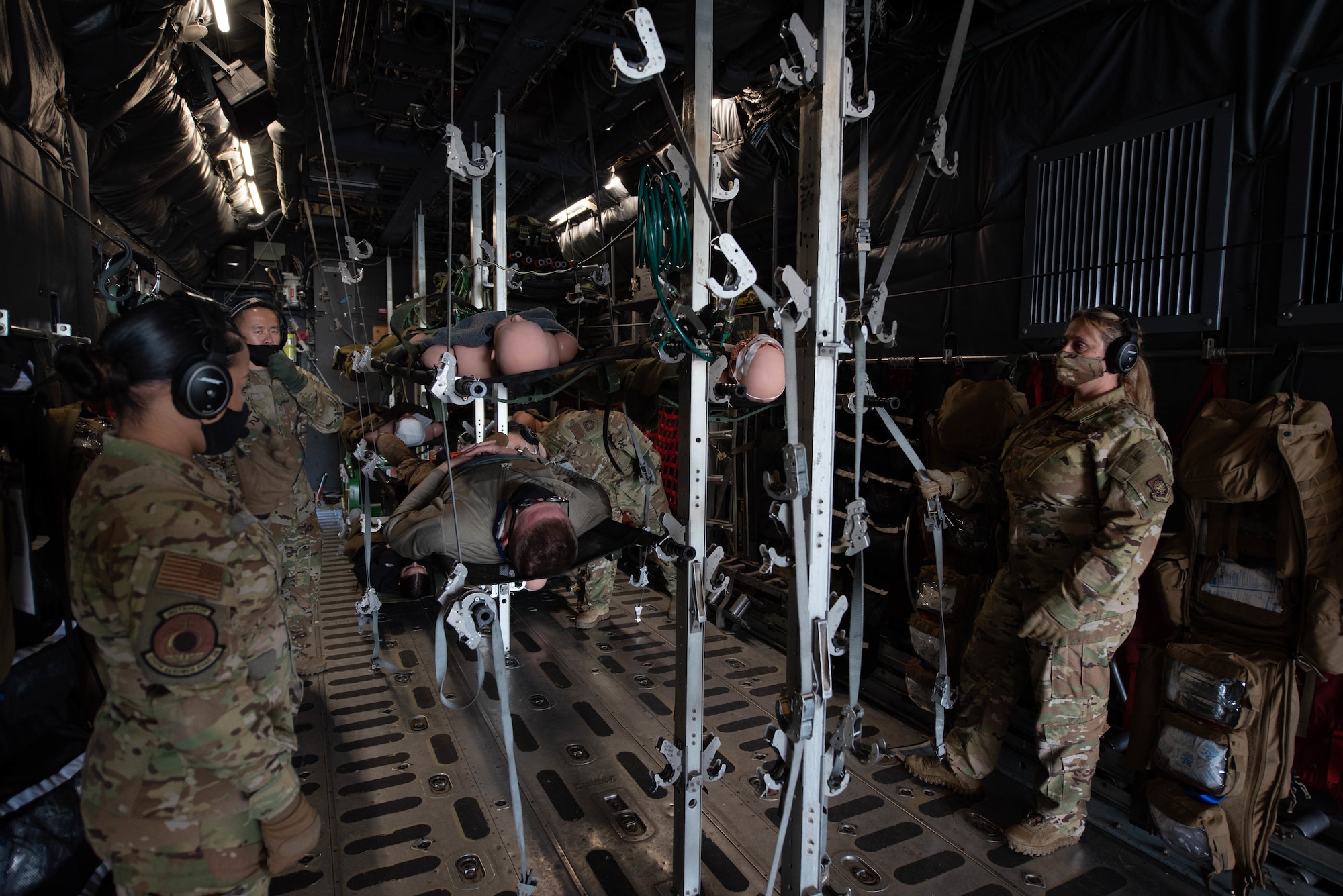 Airmen from the 375th Aeromedical Evacuation Squadron set up the Fuselage Trainer as part of a training exercise on Scott Air Force Base, Illinois, Nov. 3, 2021. Members assembled gurney stands to hold simulated patients for in-flight medical care. (U.S. Air Force photo by Airman 1st Class Stephanie Henry)