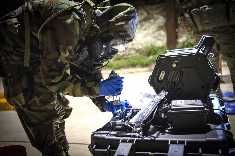 A soldier uses a detection machine.