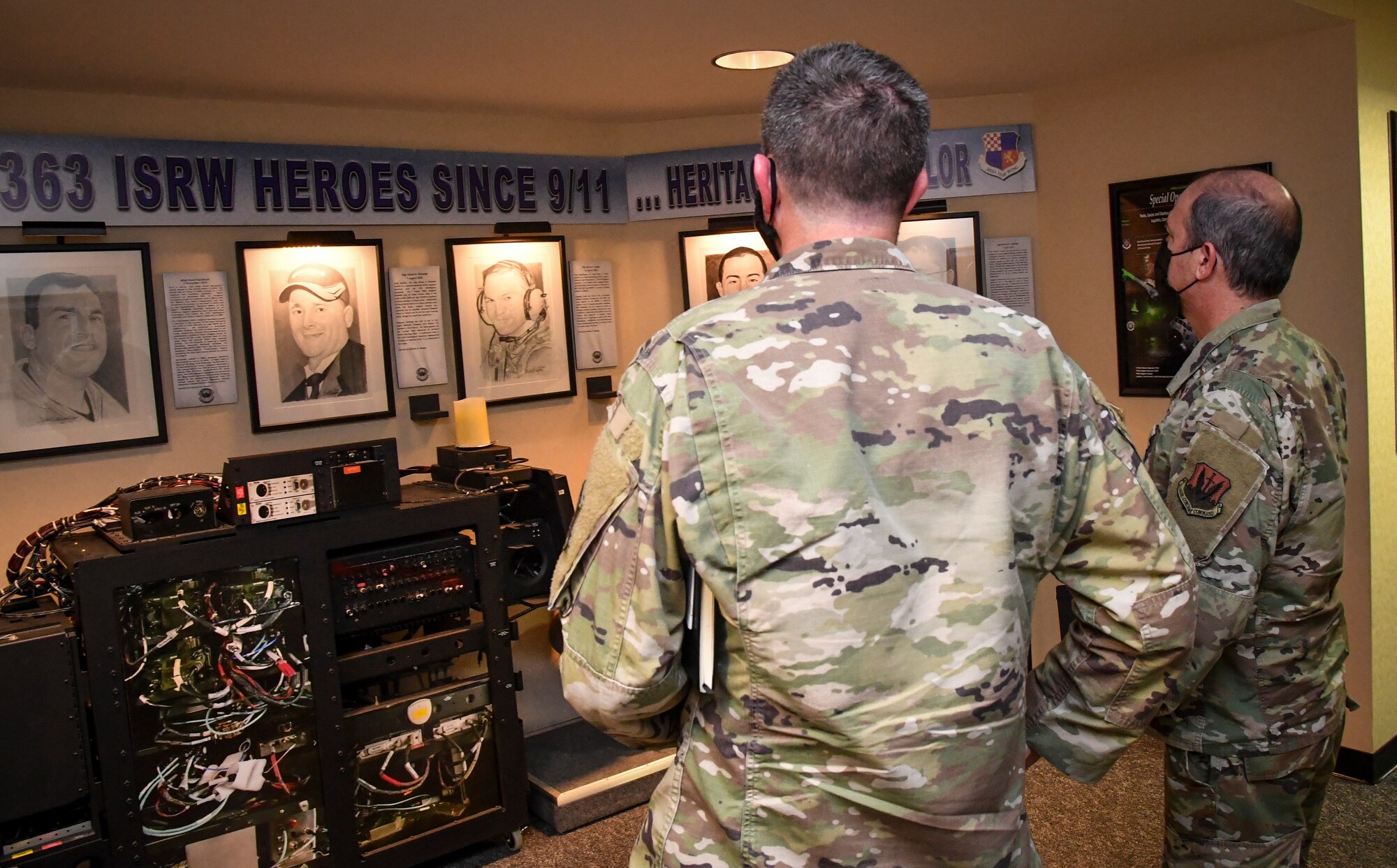 Two individuals standing looking at a display.
