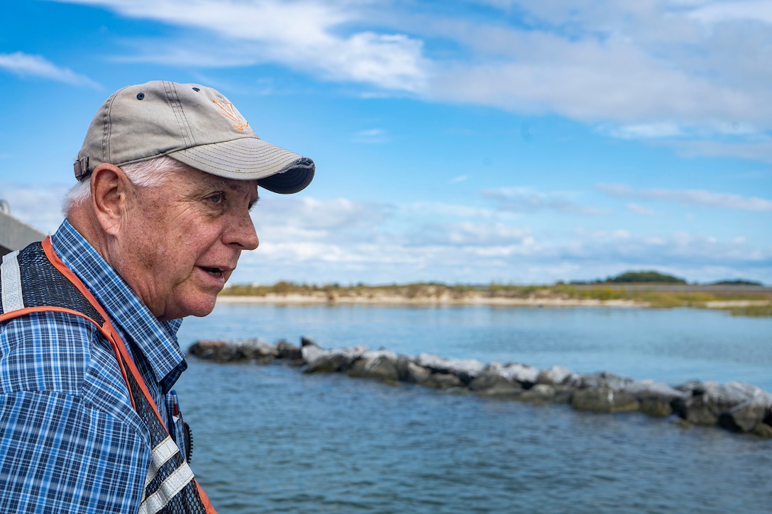 Scott Hardaway, Coastline Design and Construction, Inc., first mate, examines shoreline protection improvements during a tour of coastal resiliency projects implemented along sections of Rhodes Point, Smith Island, Md., Oct. 7, 2021. The purpose of these projects is to effectively reduce erosion along the shoreline and protect valuable habitat and human interests on the island while maintaining the ecological integrity of shoreline and nearshore environments. (U.S. Army photo by Greg Nash)