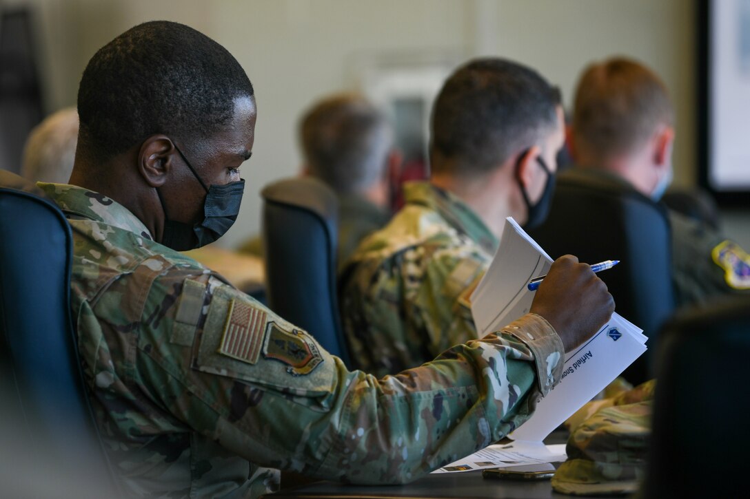 Chief Master Sgt. Ezekiel Ross, 316th Wing command chief, takes notes during the “All Things Snow" event at JBA, Md., Nov. 1, 2021.