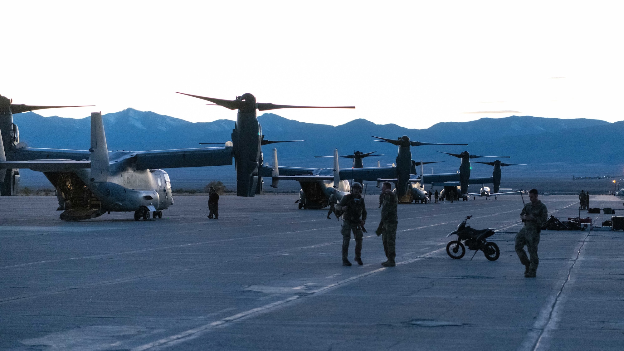 A row of Osprey Aircraft prepare to take off.