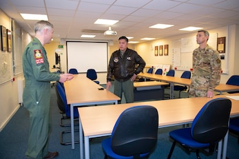 Royal Air Force Wing Commander Mike Udall, left, RAF Brize Norton Number 101 Squadron commanding officer, speaks with U.S. Air Force Col. Van Thai, center, 100th Operations Group commander, and U.S. Air Force Chief Master Sgt. Brandon Smith, 100th OG senior enlisted leader, at RAF Brize Norton, England, Nov. 2, 2021. Airmen from the 100th Air Refueling Wing conducted operations out of RAFF as part of an Agile Combat Employment exercise. The operations taking place at Fairford provide a dynamic and partnership-focused training environment which ensures U.S. forces remain postured to deliver airpower across the European theater while strengthening interoperability with our NATO allies. (U.S. Air Force photo by Senior Airman Jennifer Zima)