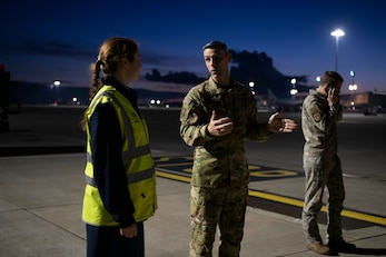 U.S. Air Force Chief Master Sgt. Brandon Smith, center, 100th Operations Group senior enlisted leader, speaks with Royal Air Force Flt. Lt. Florence Maybury, RAF Brize Norton station operations, at RAF Brize Norton, England, Nov. 2, 2021. Airmen from the 100th Air Refueling Wing conducted operations out of RAFF as part of an Agile Combat Employment exercise. The operations taking place at Fairford provide a dynamic and partnership-focused training environment which ensures U.S. forces remain postured to deliver airpower across the European theater while strengthening interoperability with our NATO allies. (U.S. Air Force photo by Senior Airman Jennifer Zima)