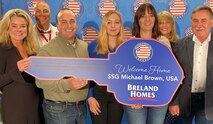 Helping A Hero honors Staff Sgt. Michael Brown, third from left, 902nd Military Intelligence Group Region 1 security manager, with an adaptive home during Lee Greenwood’s All-Star Tribute Concert, Oct. 12 at the Von Braun Center. He lost his left leg in 2007 during combat operations in Mosul, Iraq. (Courtesy photo)