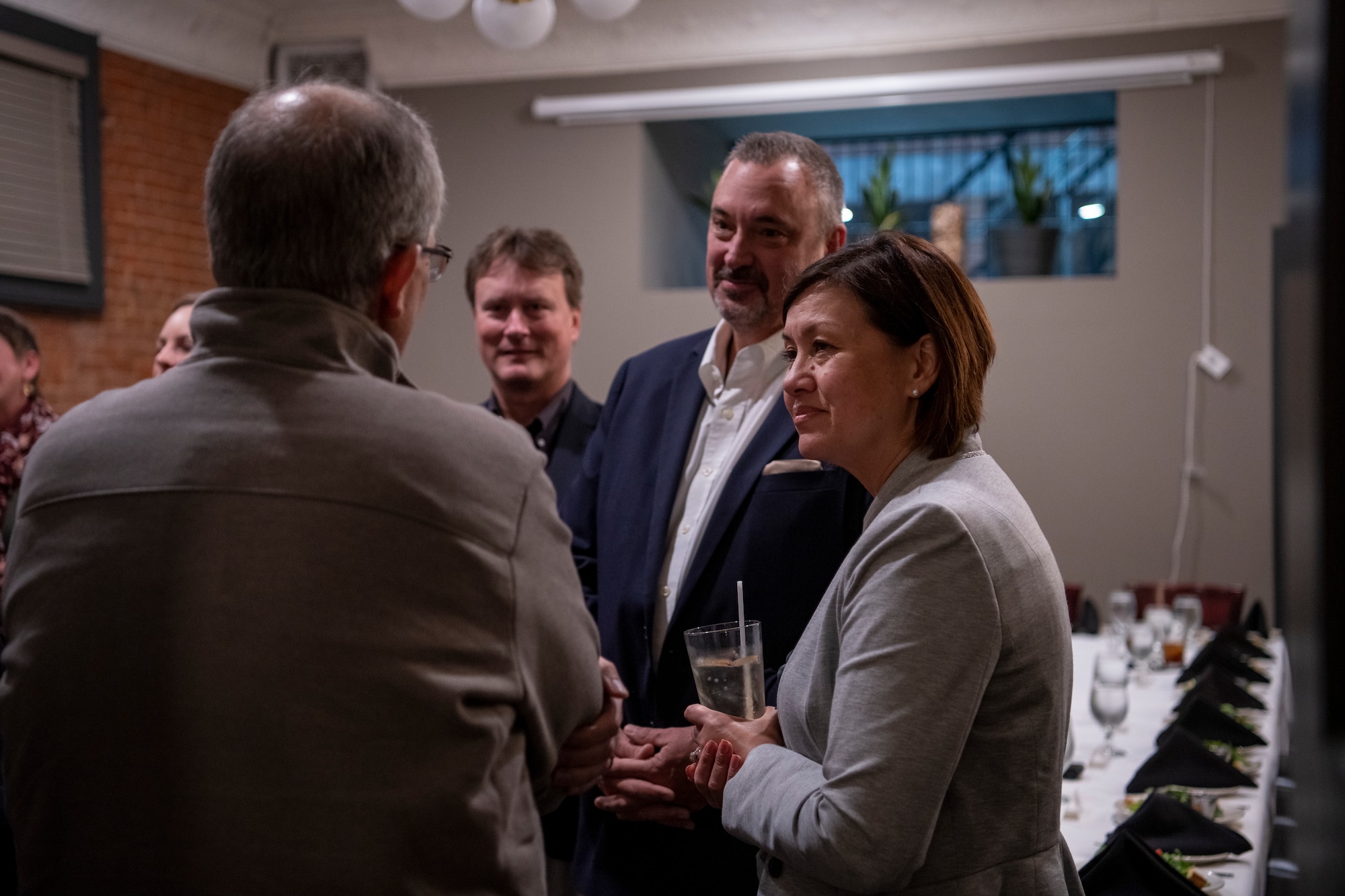 Chief Master Sgt. of the Air Force JoAnne S. Bass, right, greets Dr. David Young, Abilene Independent School District superintendent, left.