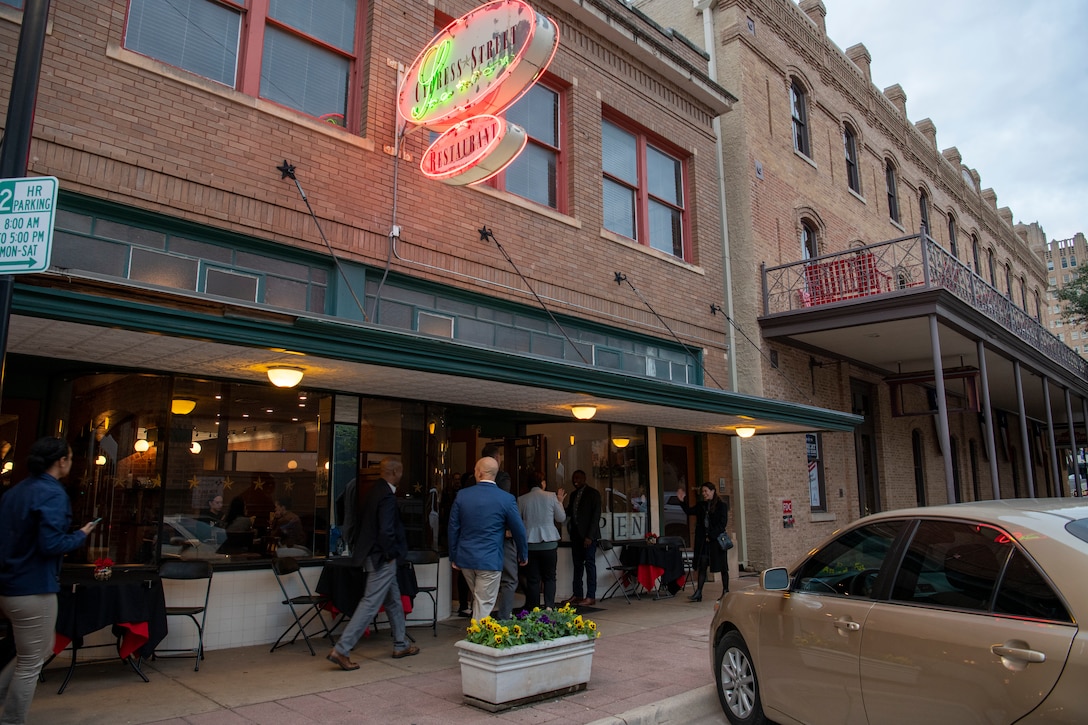 Chief Master Sgt. of the Air Force JoAnne S. Bass, middle, and her team enter a restaurant.