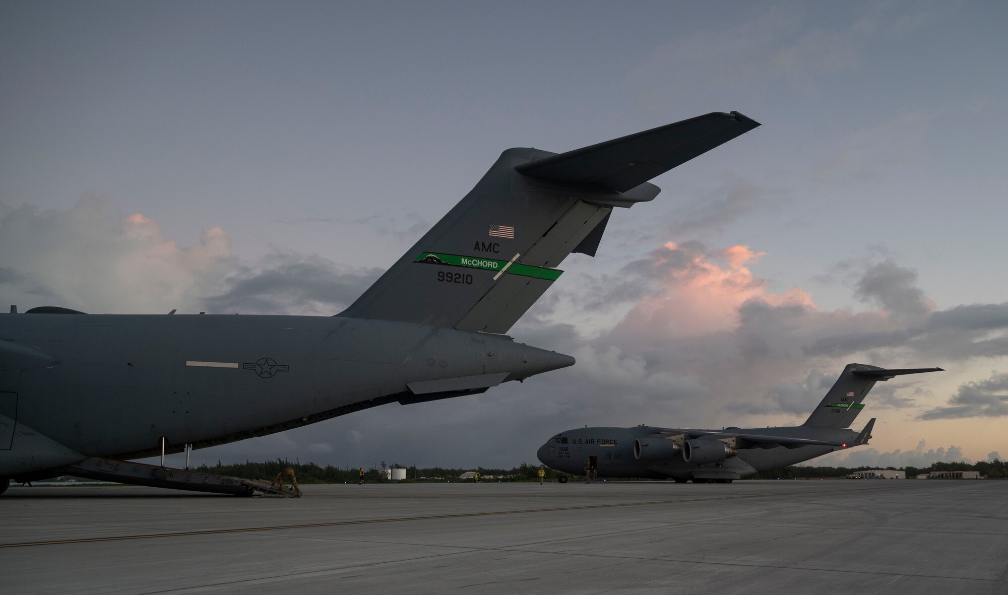 Two C-17 Globemaster IIIs assigned to Joint Base Lewis-McChord, Washington, land at Wake Island during Exercise Rainier War 21B, Nov. 5, 2021. Rainier War is a semi-annual, large readiness exercise led by the 62nd Airlift Wing, designed to train aircrews under realistic scenarios that support full spectrum readiness operations against modern threats and replicate today’s contingency operations. (U.S. Air Force photo by Staff Sgt. Rachel Williams)