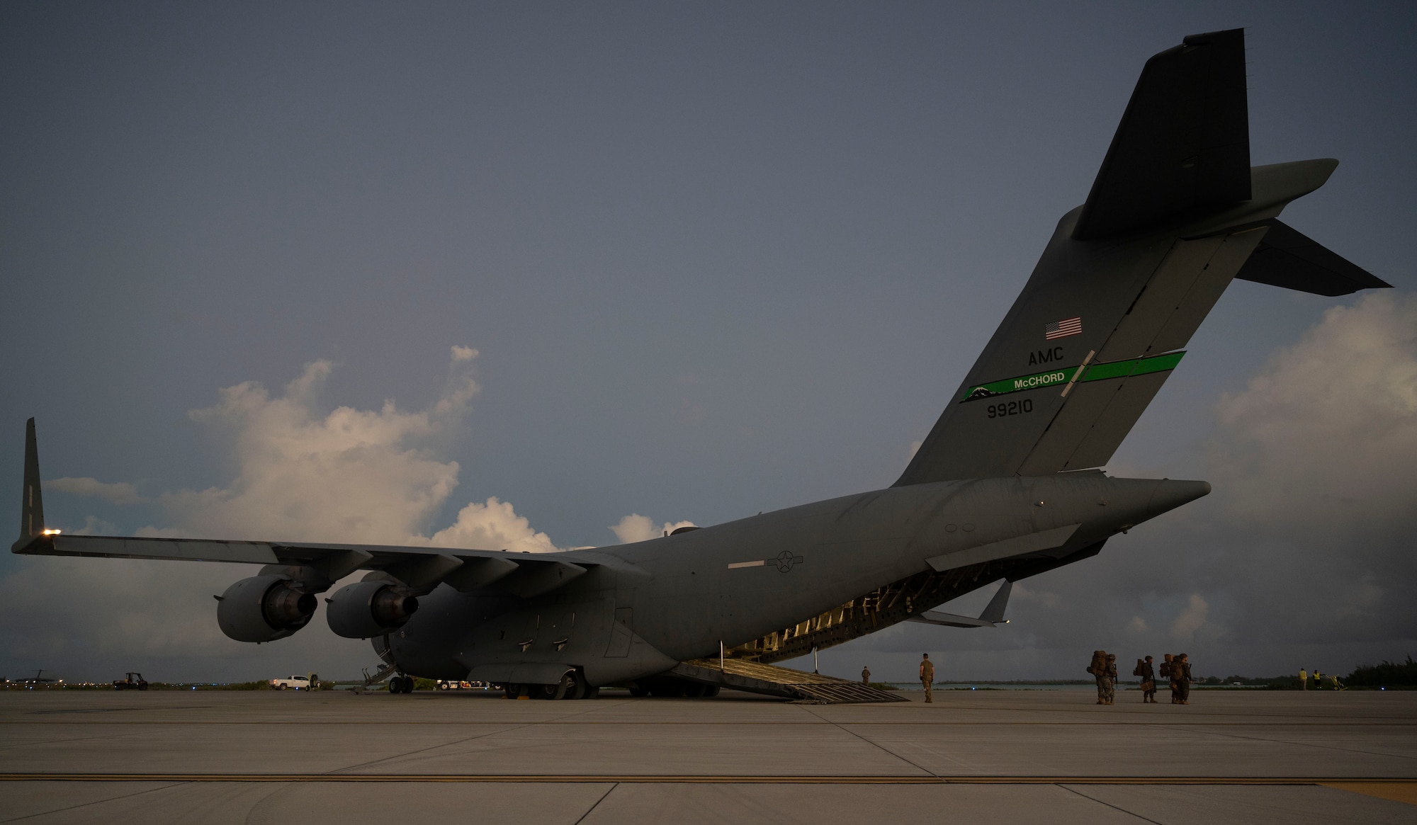 U.S. Marines, assigned to the III Marine Expeditionary Force, exit a C-17 Globemaster III during Exercise Rainier War 21B at Wake Island, Nov. 5, 2021. Rainier War 21B exercised and evaluated the 62nd Airlift Wing’s ability to employ the force and their ability to perform during wartime and contingency taskings in a high-intensity, wartime contested, degraded and operationally limited environment while supporting the contingency operations against a near-peer adversary in the U.S. Indo-Pacific Command area of responsibility. (U.S. Air Force photo by Staff Sgt. Rachel Williams)