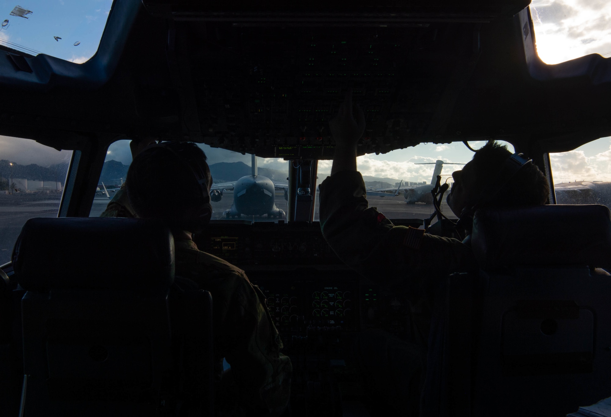 Capt. Aidan McDonald, 535th Airlift Squadron C-17 Globemaster III aircraft commander, and 1st Lt. William Anderson, 535th AS C-17 co-pilot, perform a pre-flight check during the 535th AS training week at Joint Base Pearl Harbor-Hickam, Hawaii, Nov. 3, 2021. McDonald and Anderson were accompanied by four Airmen assigned to Joint Base McGuire-Dix Lakehurst, New Jersey, from the 6th Airlift Squadron during the training. (U.S. Air Force photo by Senior Airman Alan Ricker)