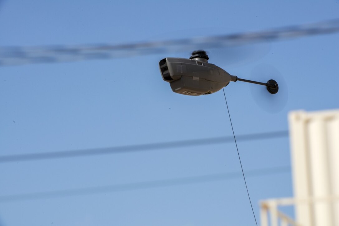 A helicopter hovers in the air.