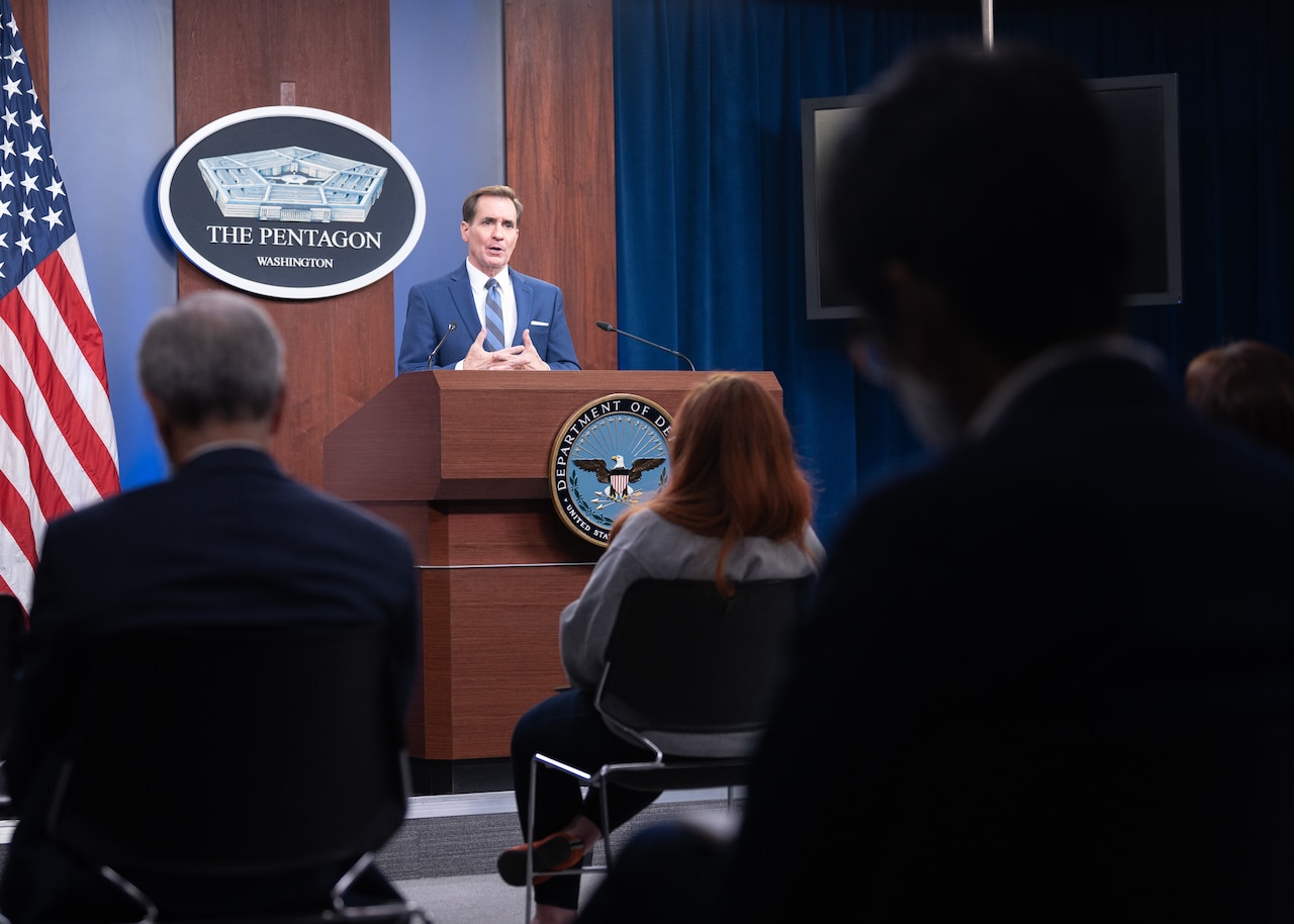 A man speaks at a podium.