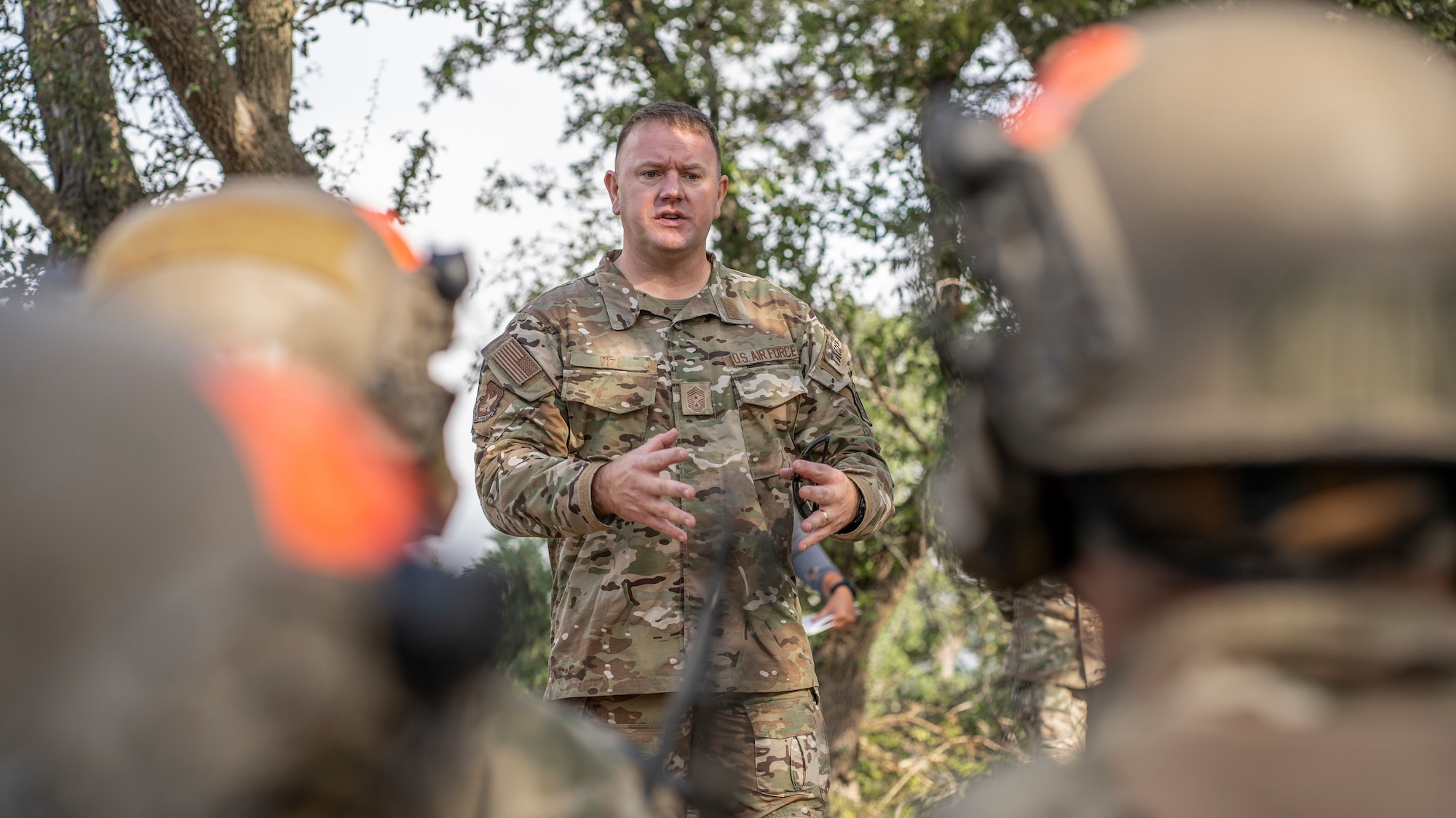 Second Air Force Command Chief Master Sgt, Adam Vizi, speaks with Tactical Air Control Party students from the 353rd Special Warfare Training Squadron during a training exercise at Joint Base San Antonio-Camp Bullis, Nov. 2, 2021.