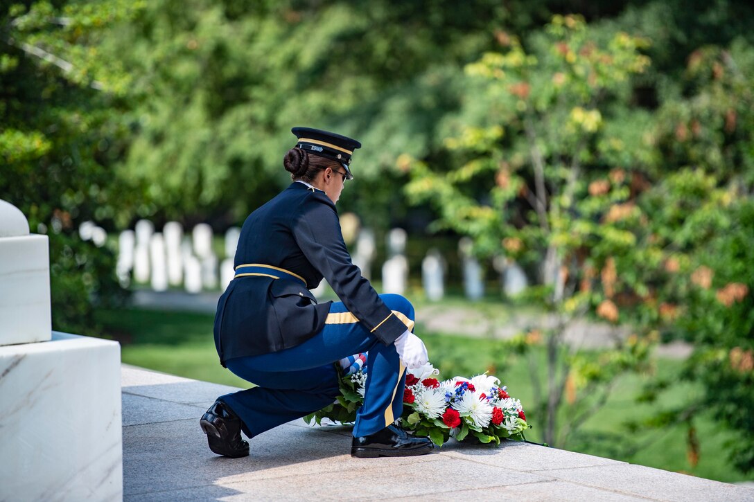 A soldier places a wreath away from the Tomb of the Unknown Soldier.