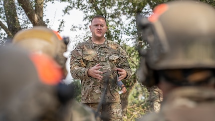 Second Air Force Command Chief Master Sgt, Adam Vizi, speaks with Tactical Air Control Party students from the 353rd Special Warfare Training Squadron during a training exercise at Joint Base San Antonio-Camp Bullis, Nov. 2, 2021.
