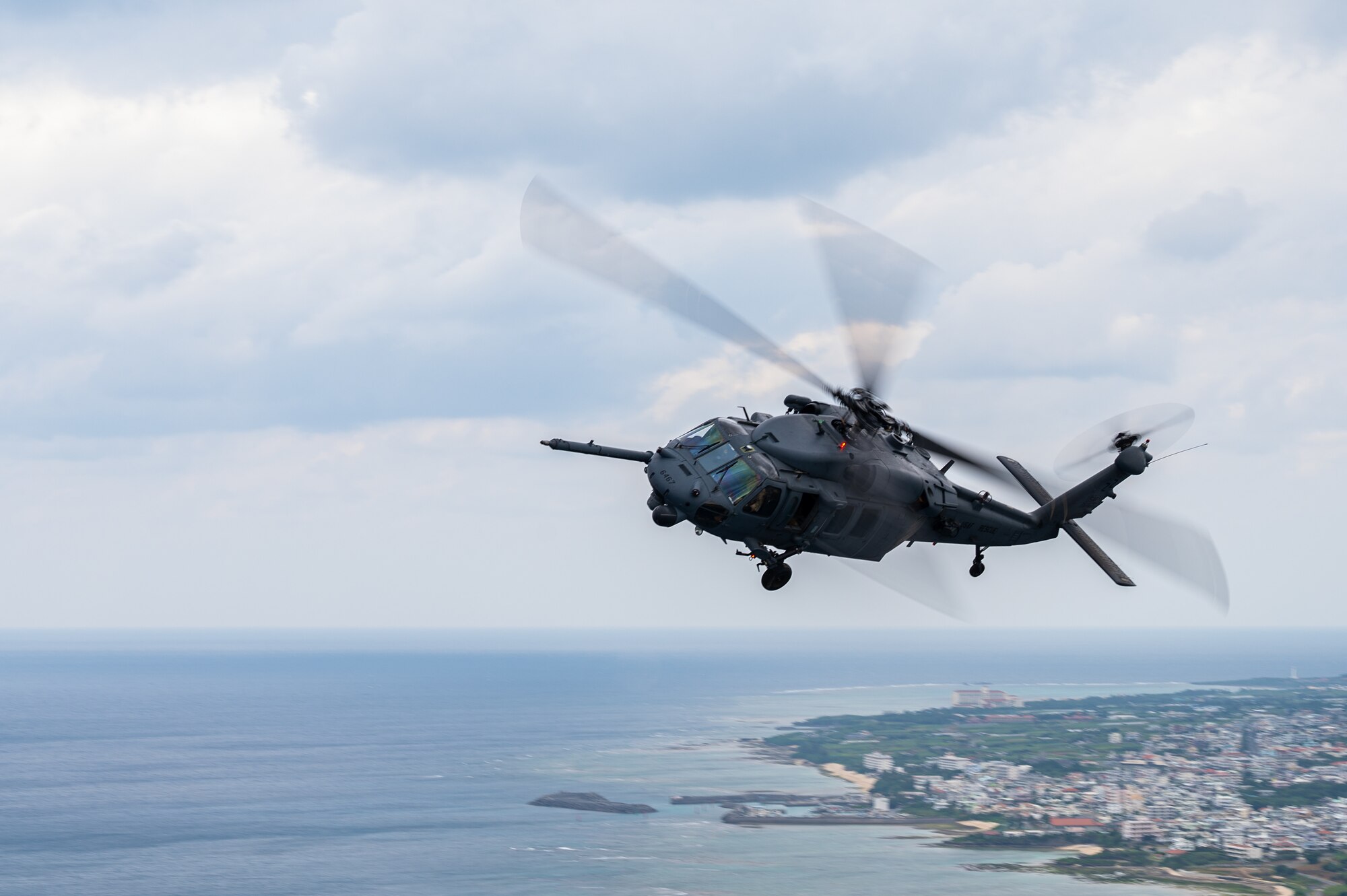A helicopter flies over Okinawa.