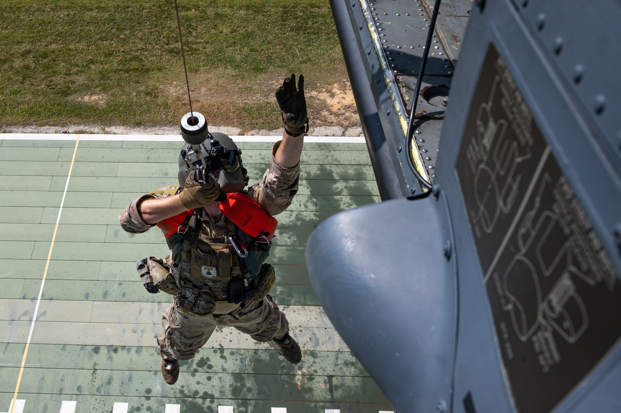 An airman hoists on a helicopter.