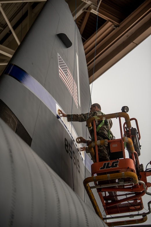 A decal is applied to the tail of a C-130J Super Hercules aircraft by Airmen from the 123rd Maintenance Group, completing the tail flash for one of the Kentucky Air National Guard’s newly acquired C-130Js at Channel Islands Air Guard Station in Port Hueneme, Calif., Nov. 3, 2021. The aircraft will be replacing the C-130H Hercules, which has been in service to the Kentucky Air National Guard since 1992. (U.S. Air National Guard photo by Tech. Sgt. Joshua Horton)