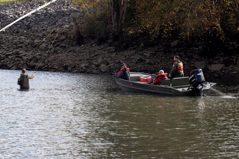 Park Ranger Gary Bruce maneuvers a Corps of Engineers vessel into position Nov. 2, 2021 to allow an Open Jaw Productions film crew to obtain imagery of Phillip Sliger fly fishing in the Caney Fork River below Center Hill Dam in Lancaster, Tennessee. Trout fishing is a popular recreation activity in the tailwater at the project operated and maintained by the U.S. Army Corps of Engineers Nashville District. The imagery is being used for a USACE National Inventory of Dams video production. (USACE Photo by Lee Roberts)