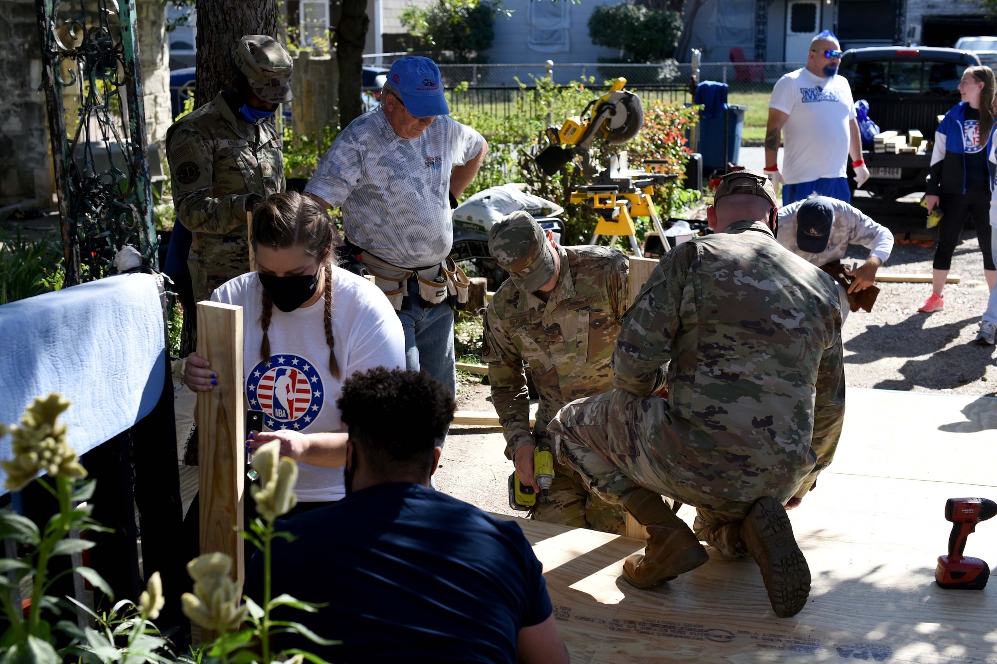 Volunteers from 301st Fighter Wing, Dallas Mavericks, and The Texas Ramp Project assemble a ramp during a Hoops for Troops event in Dallas, Texas on November 6, 2020.  The Texas Ramp Project is an opportunity for volunteers to serve their community and to learn woodworking skills. (U.S. Air Force photo by Staff Sgt. Randall Moose)