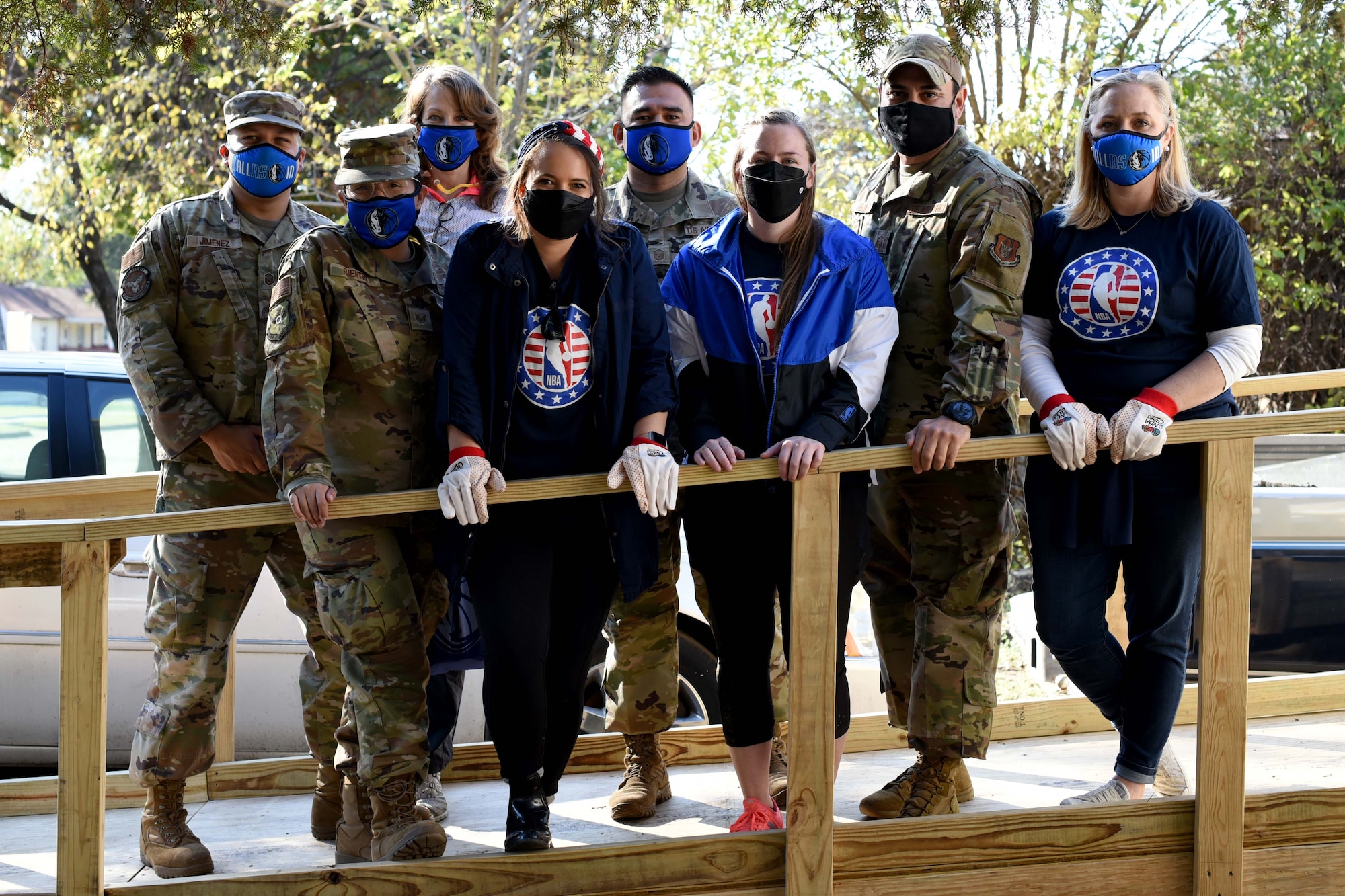 Volunteers from 301st Fighter Wing, Dallas Mavericks, and The Texas Ramp Project stand on a new ramp during a Hoops for Troops event in Dallas, Texas on November 6, 2020. The volunteers helped The Texas Ramp Project install two ramps for two homebound, low income families in Dallas. (U.S. Air Force photo by Staff Sgt. Randall Moose)
