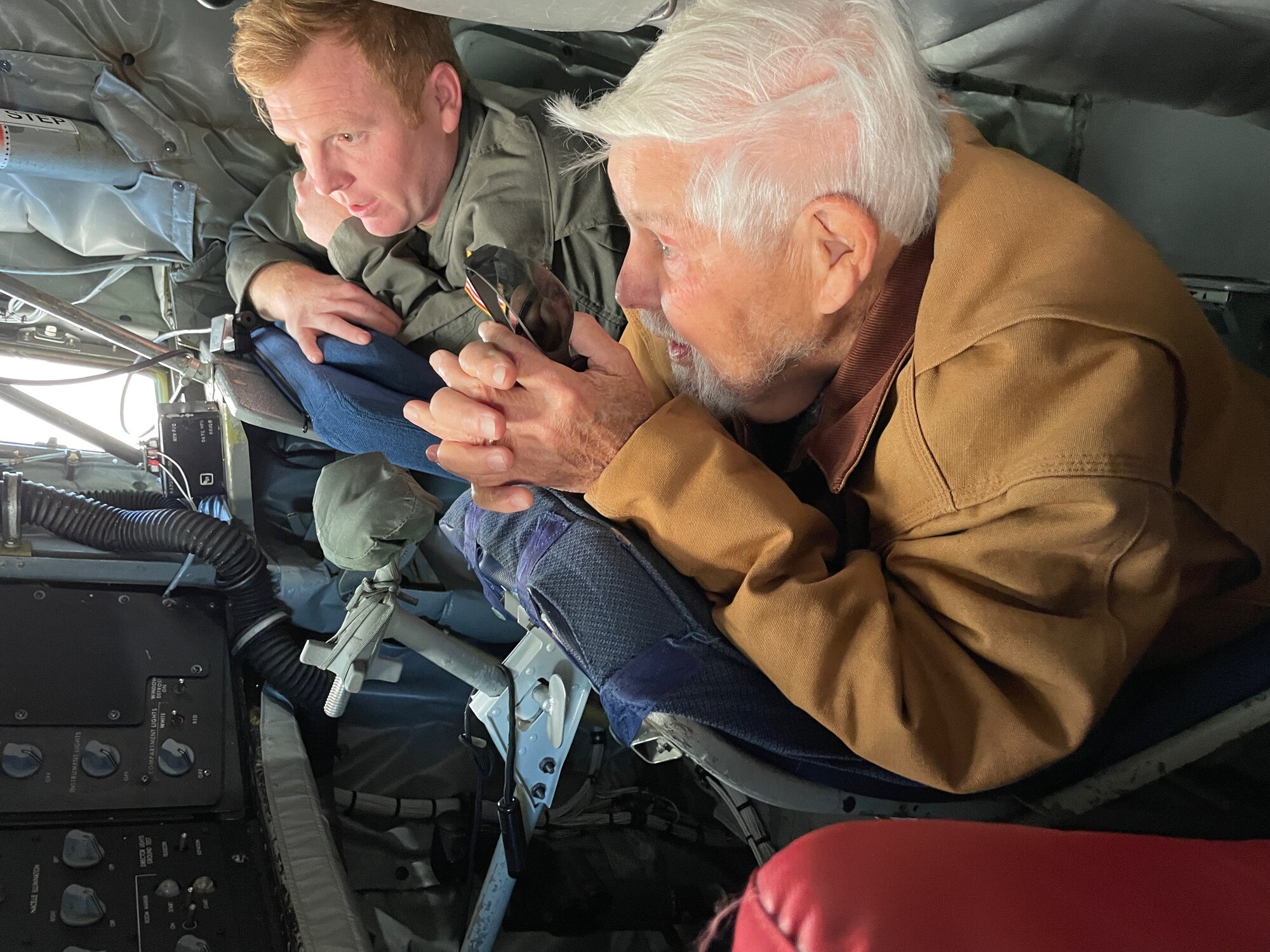 U.S. Air Force Tech. Sgt. Joshua Schultz, 186th Air Refueling Wing boom operator, shows James Roberts, a former U.S. Air Force boom operator, the controls in the boom pod of a KC-135R aircraft, Nov. 6, 2021, at Key Field Air National Guard Base, Mississippi.
