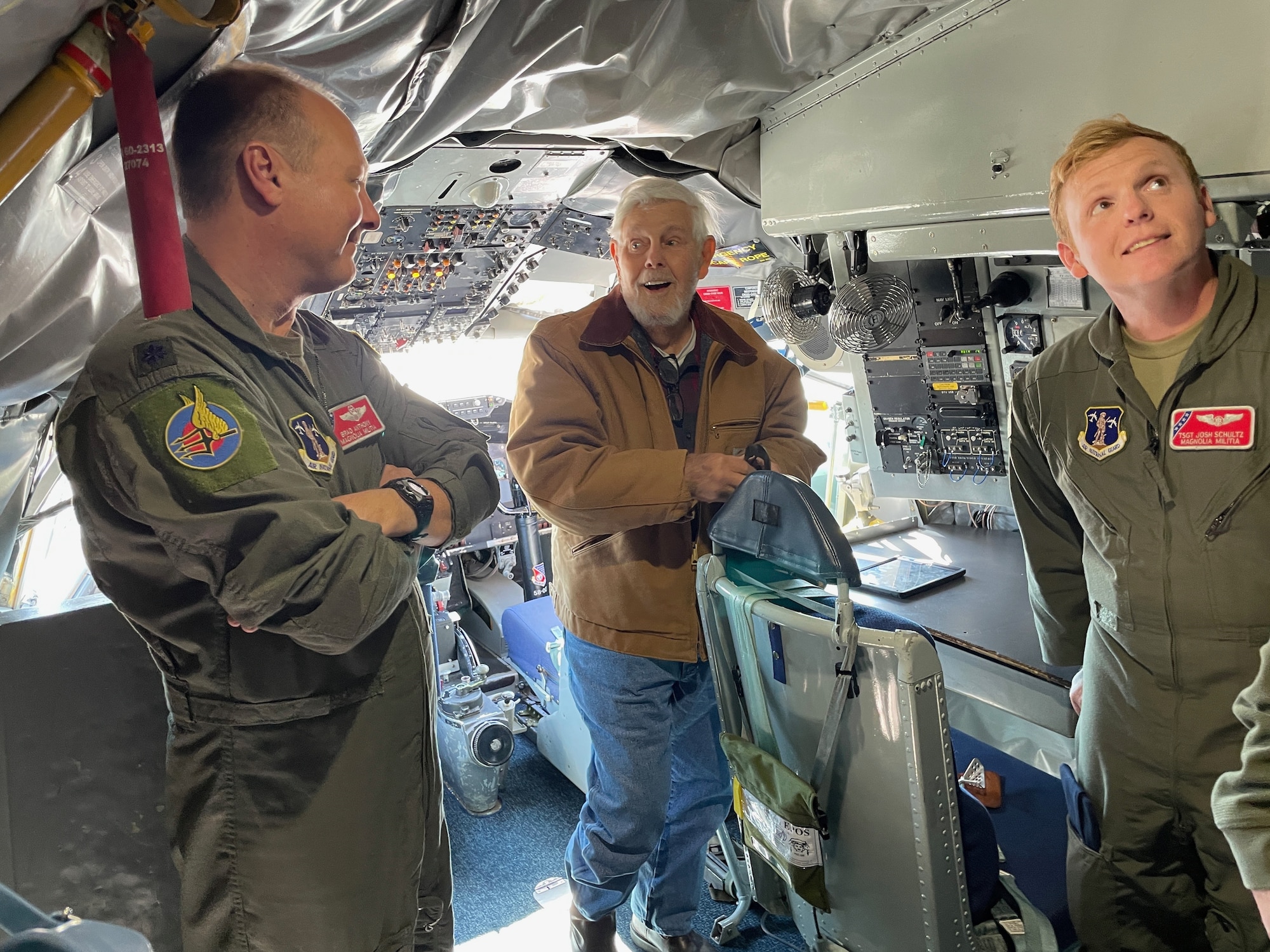 U.S. Air Force Lt. Col. Brad Anthony, a KC-135R pilot, and Tech. Sgt. Joshua Schultz, a boom operator, who are both with the 153rd Air Refueling Squadron, stand with Vietnam veteran James Roberts inside the cockpit of a KC-135R Stratotanker aircraft, Nov. 6, 2021, at Key Field Air National Guard Base, Mississippi.