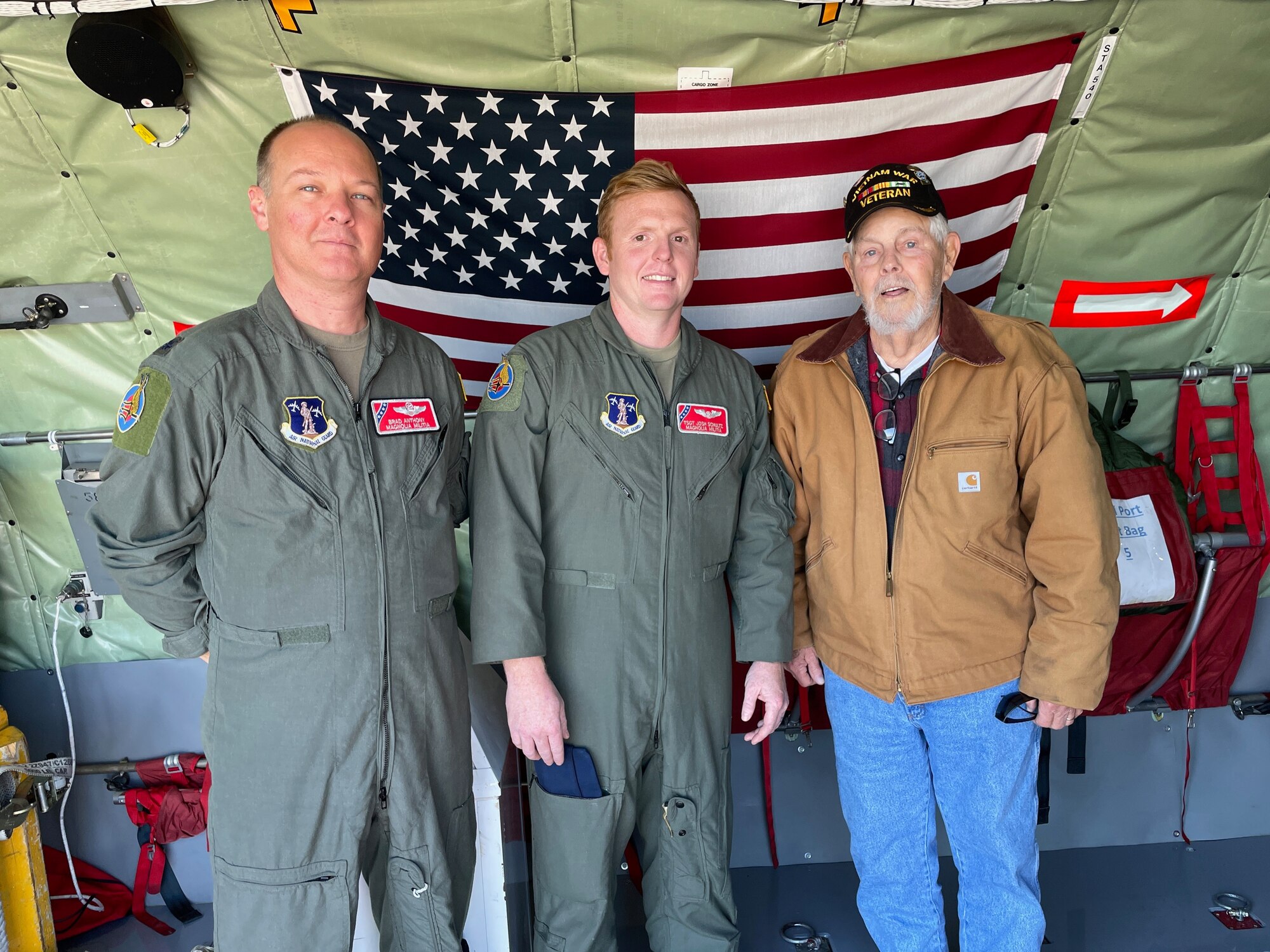 U.S. Air Force Lt. Col. Brad Anthony, a KC-135R pilot, and Tech. Sgt. Joshua Schultz, a boom operator, who are both with the 153rd Air Refueling Squadron, stand with Vietnam veteran James Roberts inside a KC-135R Stratotanker aircraft, Nov. 6, 2021, at Key Field Air National Guard Base, Mississippi.