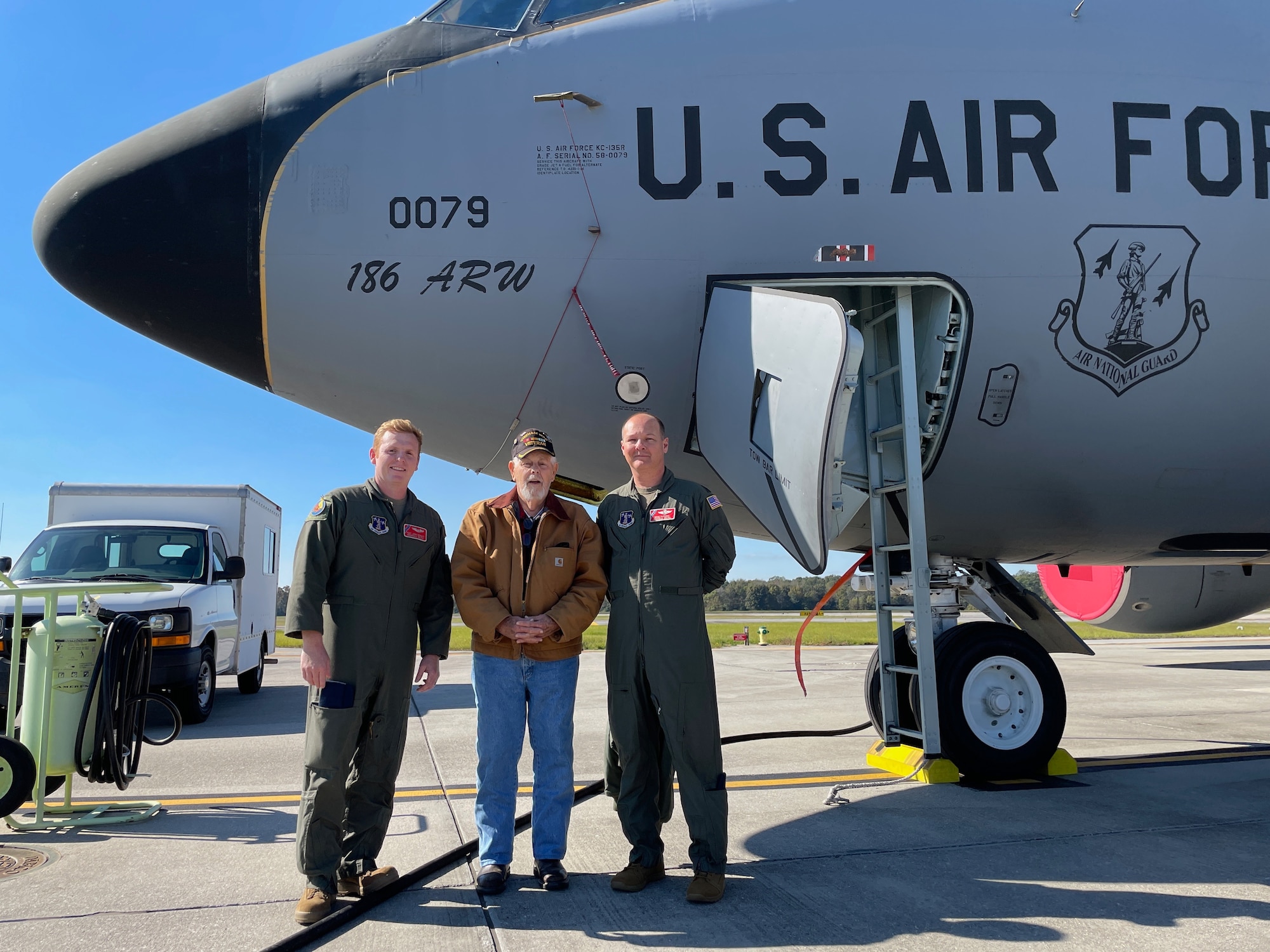 U.S. Air Force Tech. Sgt. Joshua Schultz, a boom operator, and Lt. Col. Brad Anthony, a KC-135R pilot, who are both with the 153rd Air Refueling Squadron, stand with Vietnam veteran James Roberts beside a KC-135R Stratotanker aircraft, Nov. 6, 2021, at Key Field Air National Guard Base, Mississippi.