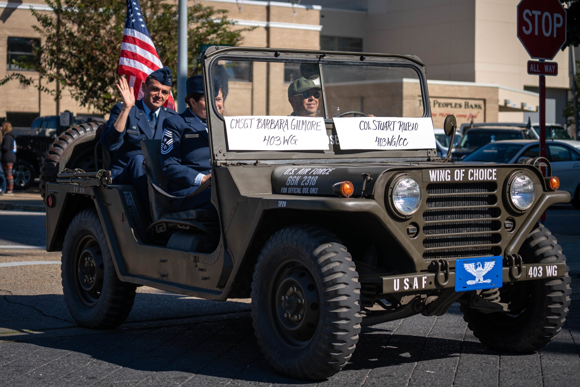 A Vietnam era Jeep with Col. Rubio in the back waving.