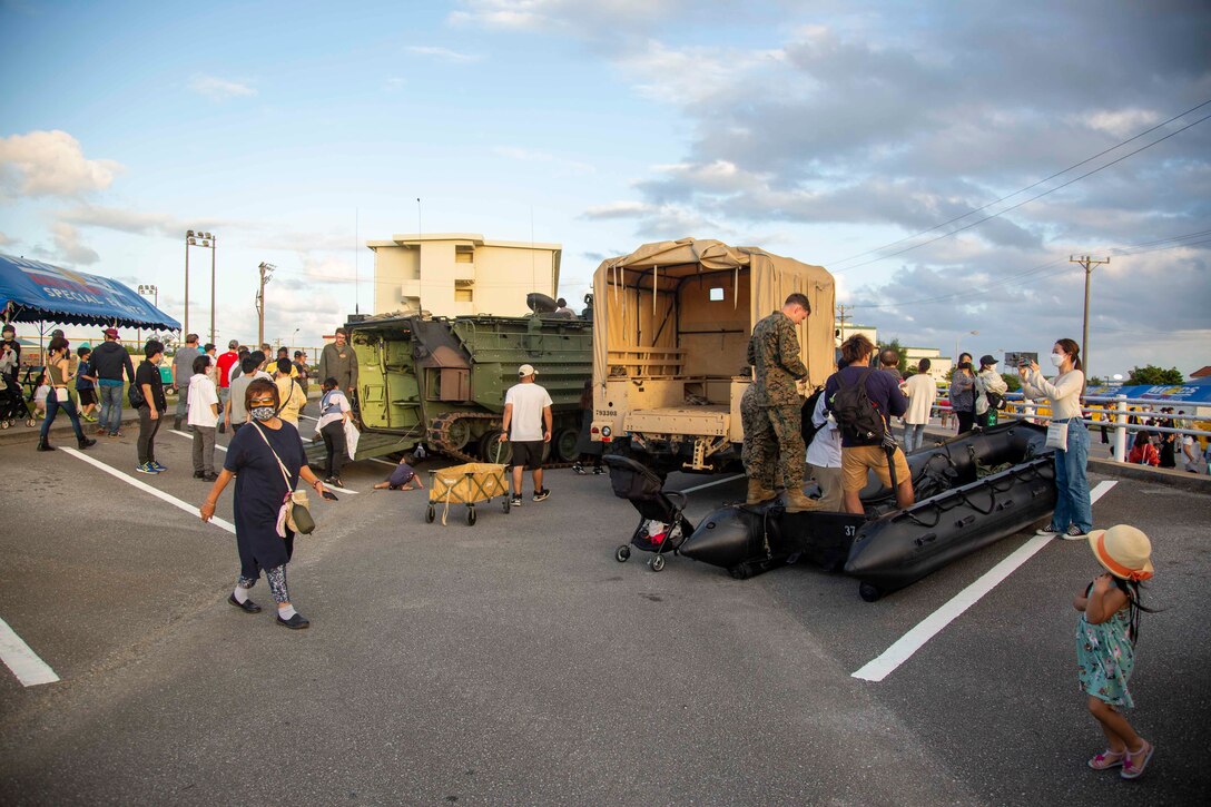 CAMP SCHWAB, OKINAWA, Japan – Okinawa residents and members of the U.S. military community on Okinawa interact with a static display of Marine Corps vehicles during an open-gate festival at Camp Schwab, Okinawa, Japan, Nov. 7, 2021. The festival was the first open-gate event hosted on Marine Corps installations in Okinawa in over a year due to COVID-19. (U.S. Marine Corps Photo by Matthew Manning)