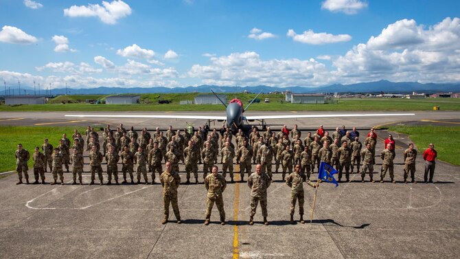 Members of the 4th Reconnaissance Squadron pose for a group photo on the flight  line at Yokota Air Base, Japan, Oct. 26, 2021.