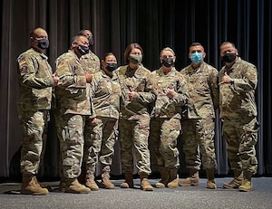 (center) Chief Master Sgt. of the Air Force JoAnne S. Bass poses for a photo with several 301st Fighter Wing Security Forces Airmen after an All-Call event at Naval Air Station Joint Reserve Base Fort Worth, Texas, Nov. 6, 2021. Chief Bass serves as the personal adviser to the Chief of Staff and the Secretary of the Air Force on all issues regarding the welfare, readiness, morale, and proper utilization and progress of more than 600,000 Total Force Airmen. She is the 19th chief master sergeant appointed to the highest noncommissioned officer position. (U.S. Air Force photo by Capt. Jessica Gross)