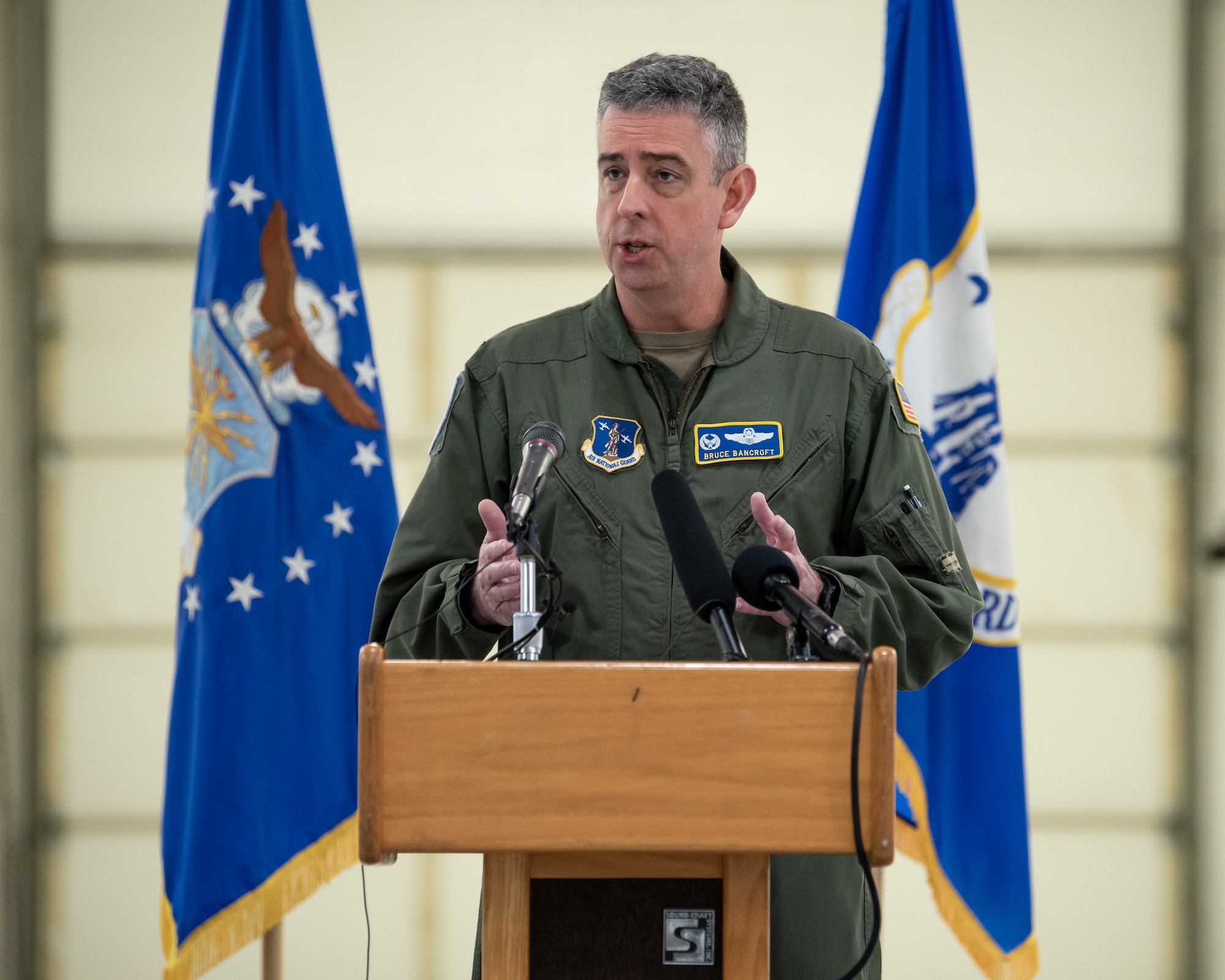 Col. Bruce Bancroft, commander of the 123rd Airlift Wing, speaks to audience members during a ceremony at the Kentucky Air National Guard Base in Louisville, Ky., Nov. 6, 2021, to welcome the arrival of two new C-130J Super Hercules aircraft. The state-of-the-art transports are among eight that the wing will receive over the next 11 months to replace eight aging C-130 H-model aircraft, which entered service in 1992 and have seen duty all over the world. (U.S. Air National Guard photo by Dale Greer)