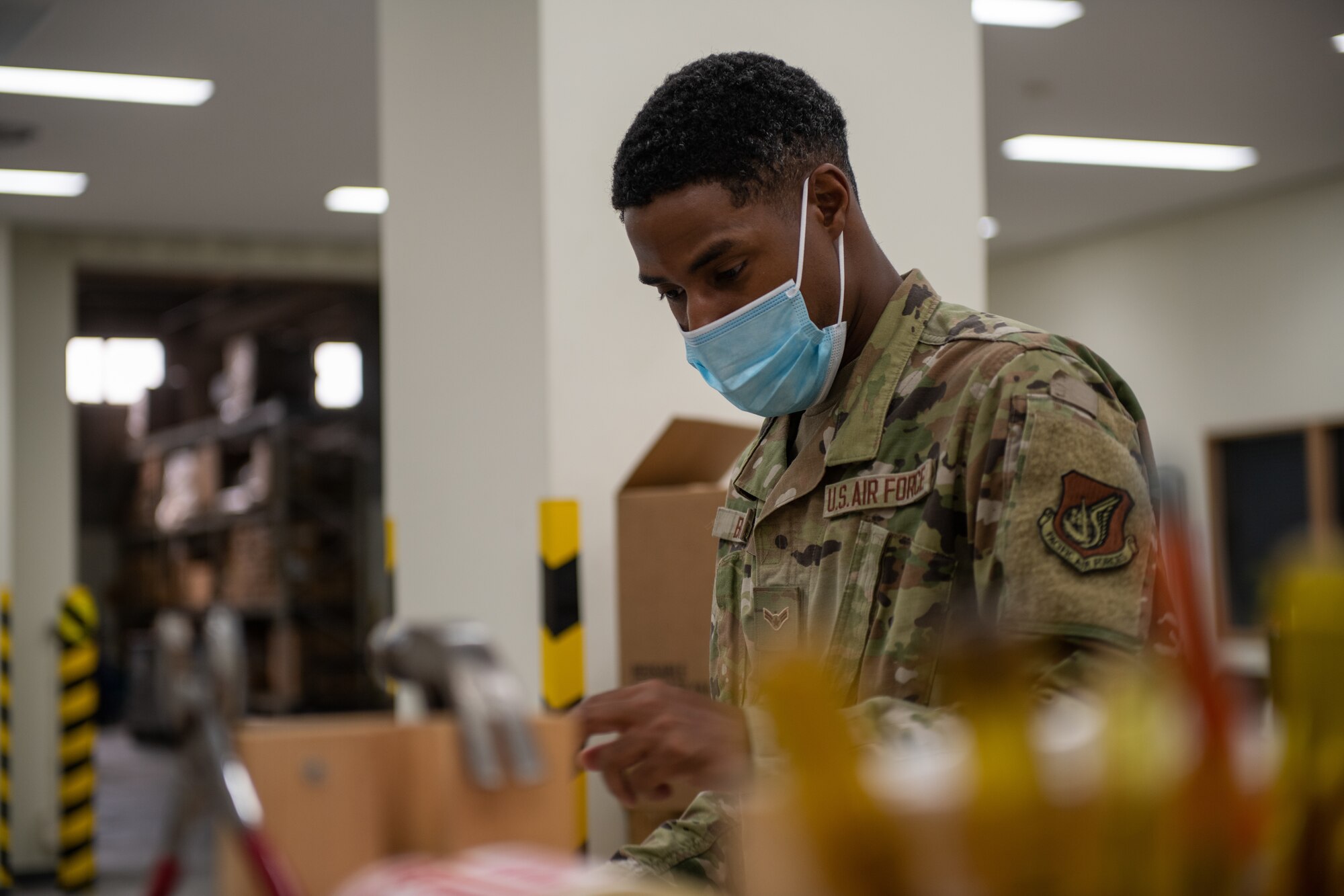 An Airman applies a label to a package