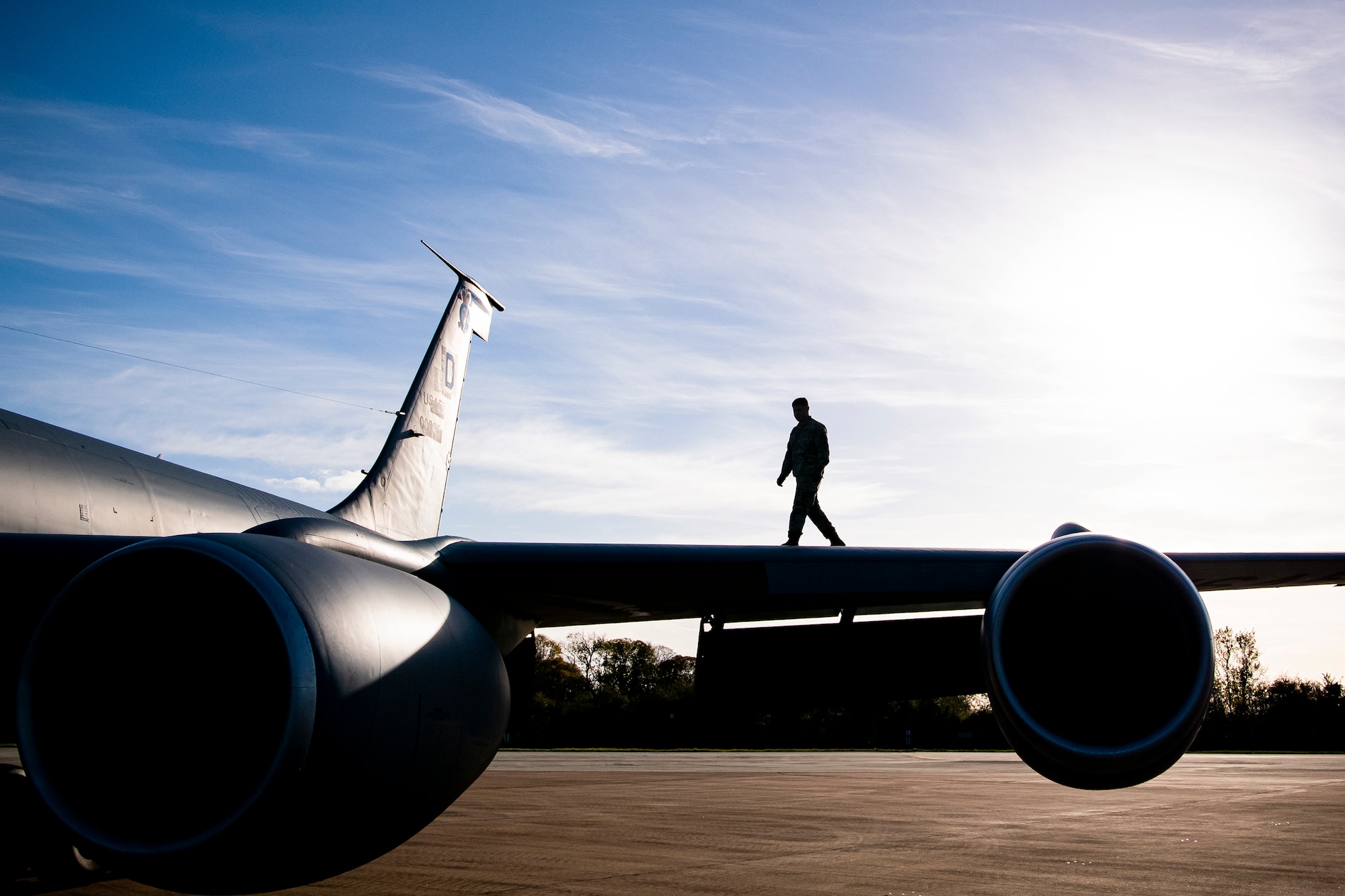 An Airman from the 100th Aircraft Maintenance Squadron walks on the wing of a KC-135 Stratotanker at RAF Fairford, England, Nov. 1, 2021. Airmen from the 100th Air Refueling Wing conducted operations out of RAFF as part of an Agile Combat Employment exercise. The operations taking place at Fairford provide a dynamic and partnership-focused training environment which ensures U.S. forces remain postured to deliver airpower across the European theater while strengthening interoperability with our NATO allies. (U.S. Air Force photo by Senior Airman Eugene Oliver)