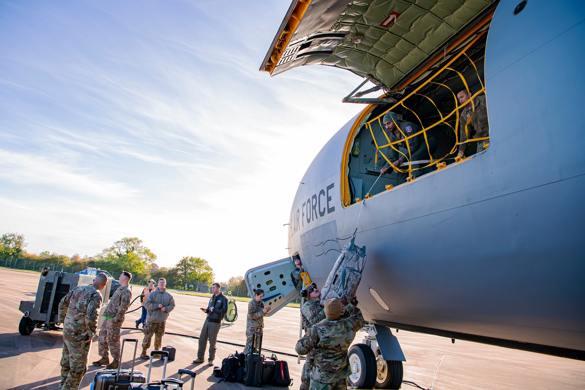 Airmen from the 100th Aircraft Maintenance Squadron and 351st Air Refueling Squadron unload cargo from a KC-135 Stratotanker at RAF Fairford, England, Nov. 1, 2021. Airmen from the 100th Air Refueling Wing conducted operations out of RAFF as part of an Agile Combat Employment exercise. Utilizing ACE concepts ensures that U.S. forces in Europe are better equipped to operate from locations with varying levels of capacity and support to accomplish the mission. (U.S. Air Force photo by Senior Airman Eugene Oliver)