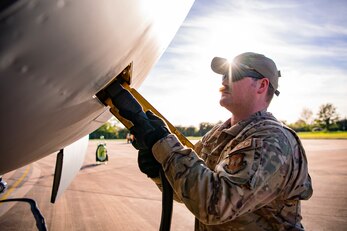Staff Sgt. Benjamin Kellum, 100th Aircraft Maintenance Squadron flying crew chief, plugs in a power cord into a KC-135 Stratotanker at RAF Fairford, England, Nov. 1, 2021. Airmen from the 100th Air Refueling Wing conducted operations out of RAFF as part of an Agile Combat Employment exercise. Utilizing ACE concepts ensures that U.S. forces in Europe are better equipped to operate from locations with varying levels of capacity and support to accomplish the mission. This further ensures Airmen and aircrews are postured to deliver lethal combat power across the full spectrum of military operations. (U.S. Air Force photo by Senior Airman Eugene Oliver)
