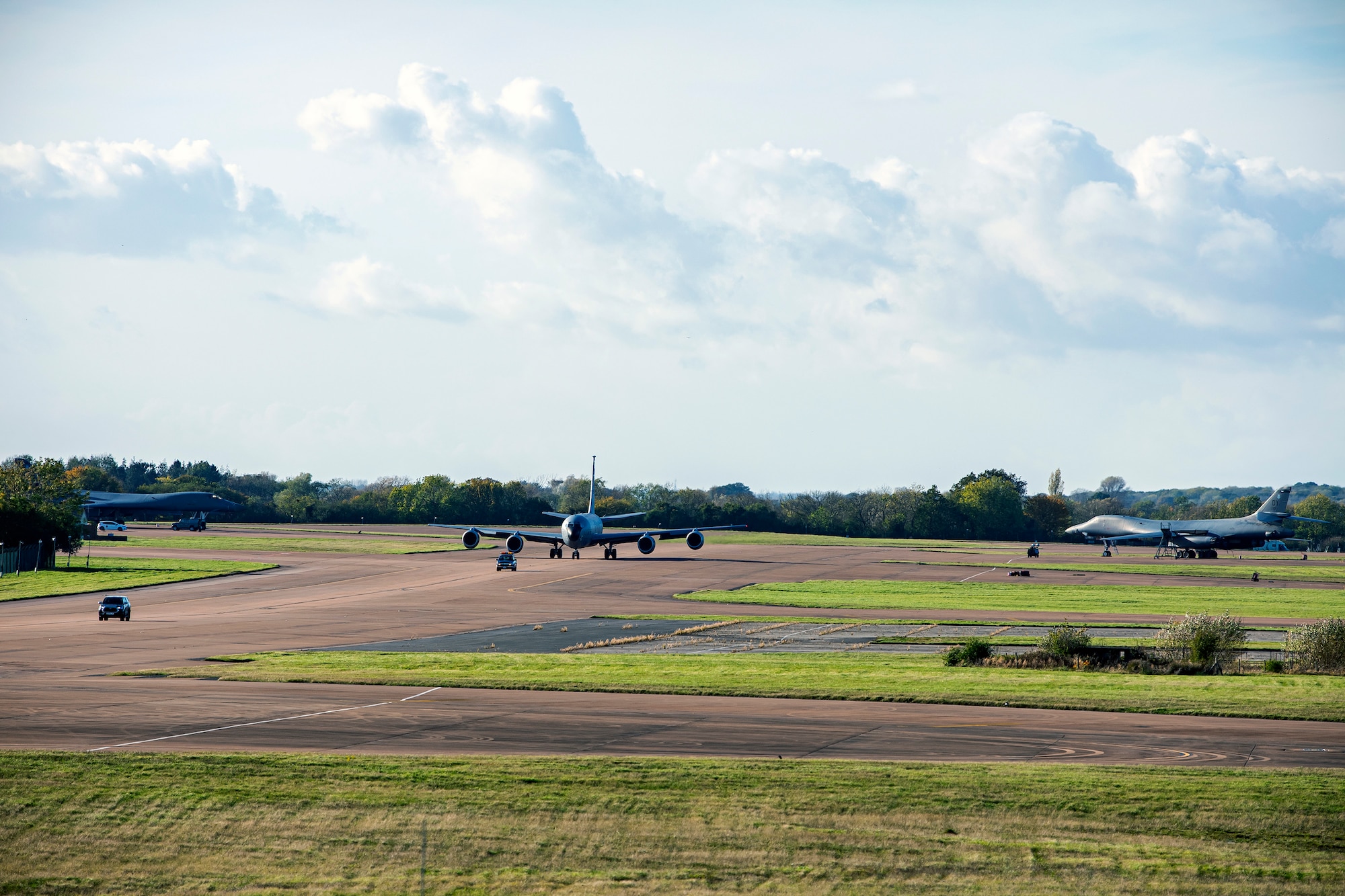 A KC-135 Stratotanker assigned to the 100th Air Refueling Wing, center, taxis on the runway at RAF Fairford, England, Nov. 1, 2021. Airmen from the 100th ARW conducted operations out of RAFF as part of an Agile Combat Employment exercise. The operations taking place at Fairford provide a dynamic and partnership-focused training environment which ensures U.S. forces remain postured to deliver airpower across the European theater while strengthening interoperability with our NATO allies. (U.S. Air Force photo by Senior Airman Eugene Oliver)