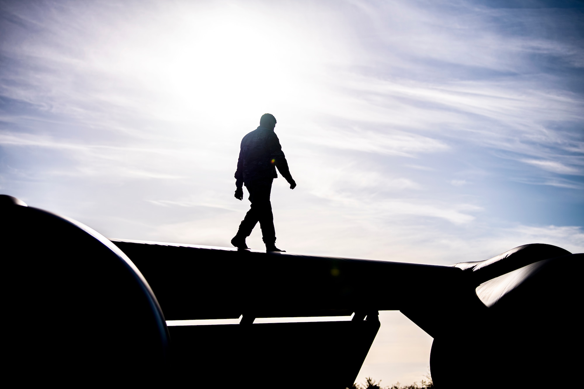 An Airman from the 100th Aircraft Maintenance Squadron walks on the wing of a KC-135 Stratotanker at RAF Fairford, England, Nov. 1, 2021. Airmen from the 100th Air Refueling Wing conducted operations out of RAFF as part of an Agile Combat Employment exercise. ACE enables U.S. forces in Europe to operate from locations with varying levels of capacity and support. This further ensures Airmen and aircrews are postured to deliver lethal combat power across the full spectrum of military operations. (U.S. Air Force photo by Senior Airman Eugene Oliver)