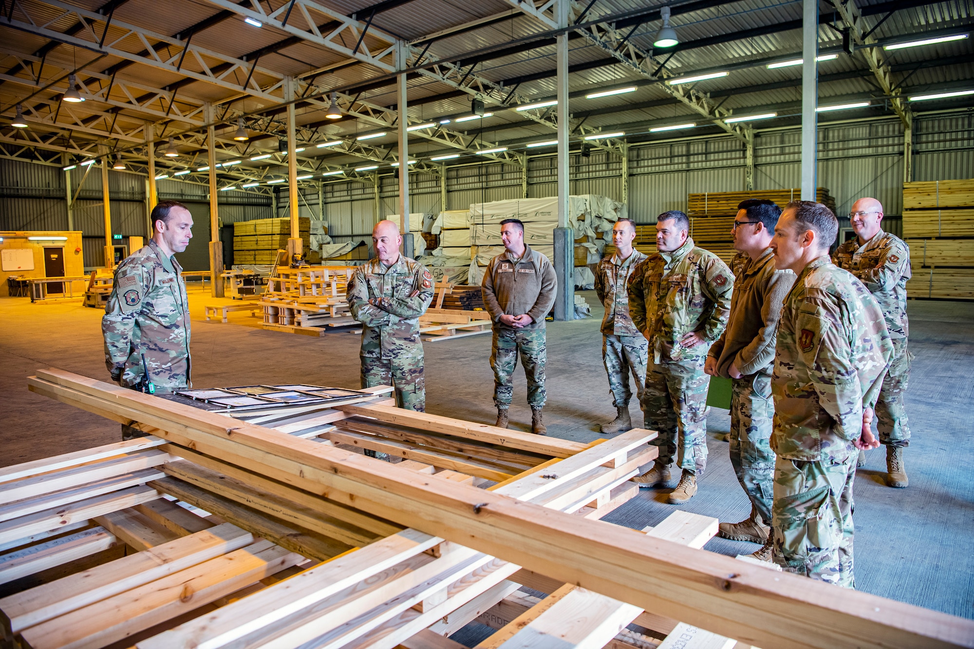 U.S. Air Force Tech. Sgt. Brandon Mullenix, 420th Munitions Squadron conventional maintenance section chief, left, speaks with Brig. Gen. George T. Dietrich III, center right, U.S. Air Forces in Europe - Air Forces Africa director of logistics, engineering and force protection, at RAF Welford, England, Nov. 4, 2021. Dietrich visited with Airmen from five geographically separated units across the wing and learned more about the unique mission of the 501st CSW. (U.S. Air Force photo by Senior Airman Eugene Oliver)