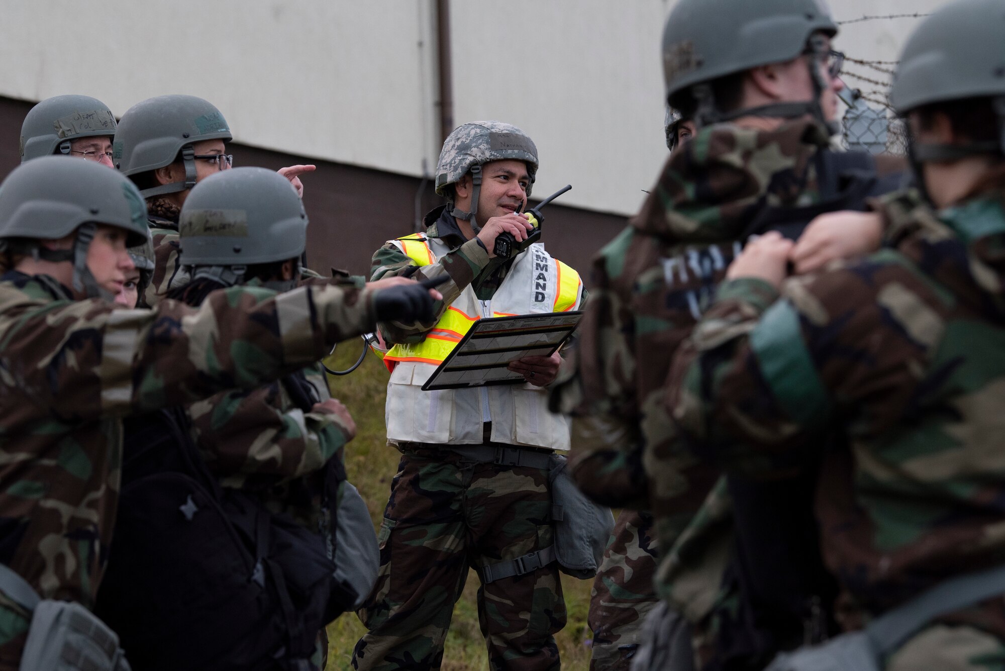 U.S. Air Force Master Sgt. Nathan Salas, 52nd Civil Engineer Squadron assistant chief of A-shift operations, communicates through a radio during exercise Sabre Storm, Nov. 4, 2021, on Spangdahlem Air Base, Germany. Salas participated in a simulated mass casualty response, and directed 52nd Fire and Emergency Services flight Airmen during the exercise. (U.S. Air Force photo by Tech. Sgt. Anthony Plyler)