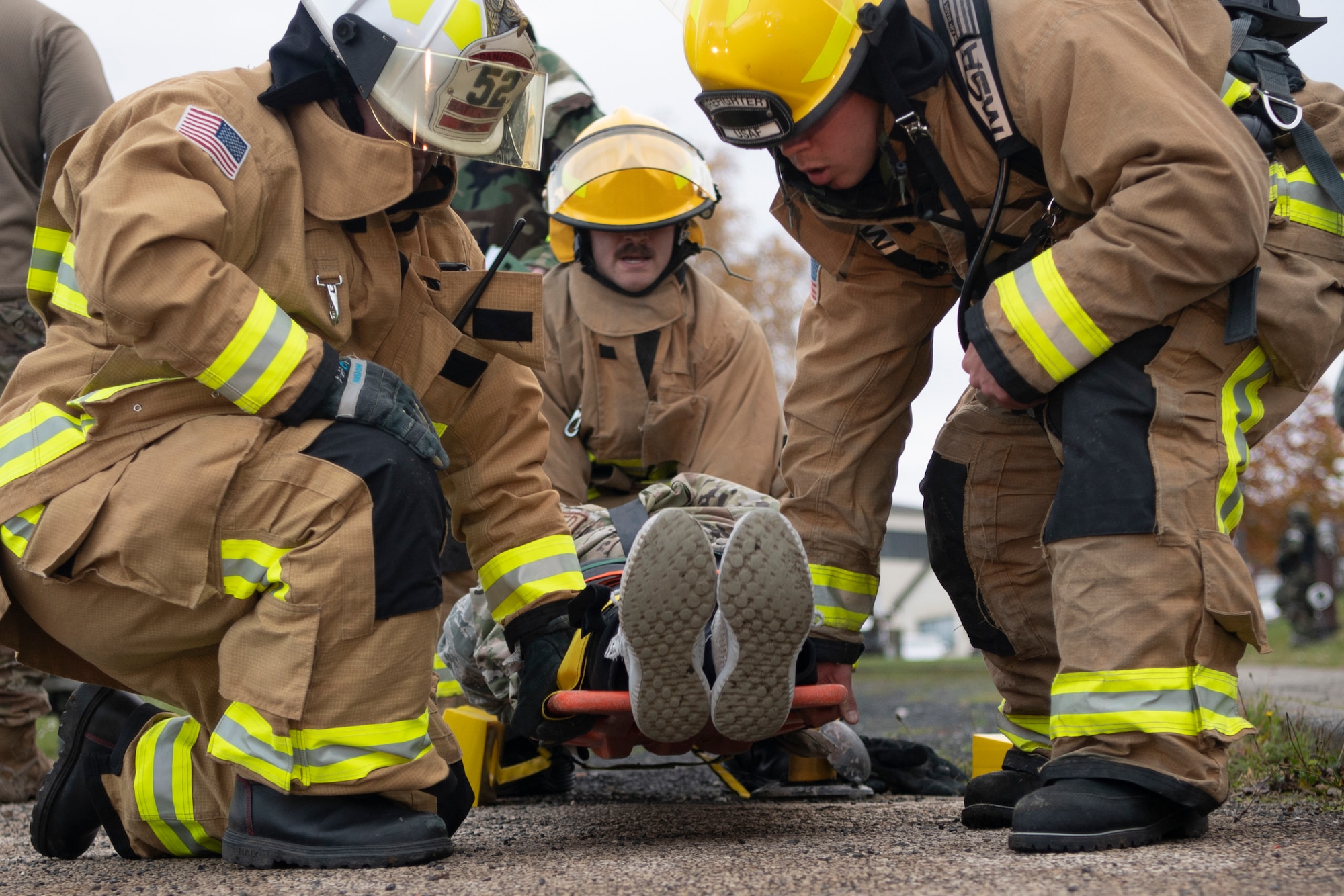 U.S. Air Force Airmen from the 52nd Civil Engineer Squadron Fire and Emergency Services flight respond to a mock patient during a mass casualty simulation, Nov. 4, 2021, on Spangdahlem Air Base, Germany. The 52nd Fighter Wing hosted exercise Sabre Storm, where 52nd FW Airmen were tested on readiness, vigilance and response times. (U.S. Air Force photo by Staff Sgt. Melody W. Howley)