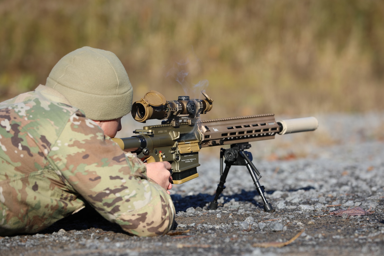 Smoke clears from the chamber of an M110 A1 Squad Designated Marksman Rifle fired by Spc. Steven Monnat, an infantryman assigned to the New York National Guard's Headquarters and Headquarters Company, 2nd Battalion, 108th Infantry Regiment, during new equipment training at Fort Drum, New York, Nov. 5, 2021. Monnat was among 30 Soldiers from the battalion's higher headquarters, the 27th Infantry Brigade Combat Team, who learned to operate the SDMR and close the gap between the reach of a rifleman and a sniper's weapons.