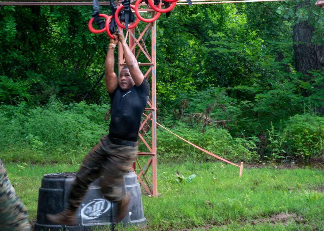 U.S. Marine SSgt Raheem Boyd goes over obstacles during the Scars and Stripes Mud Run on June 5, 2021.